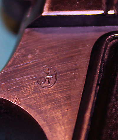 Close-up on the 4UT acceptance stamp on the right tang of the Beretta M1935